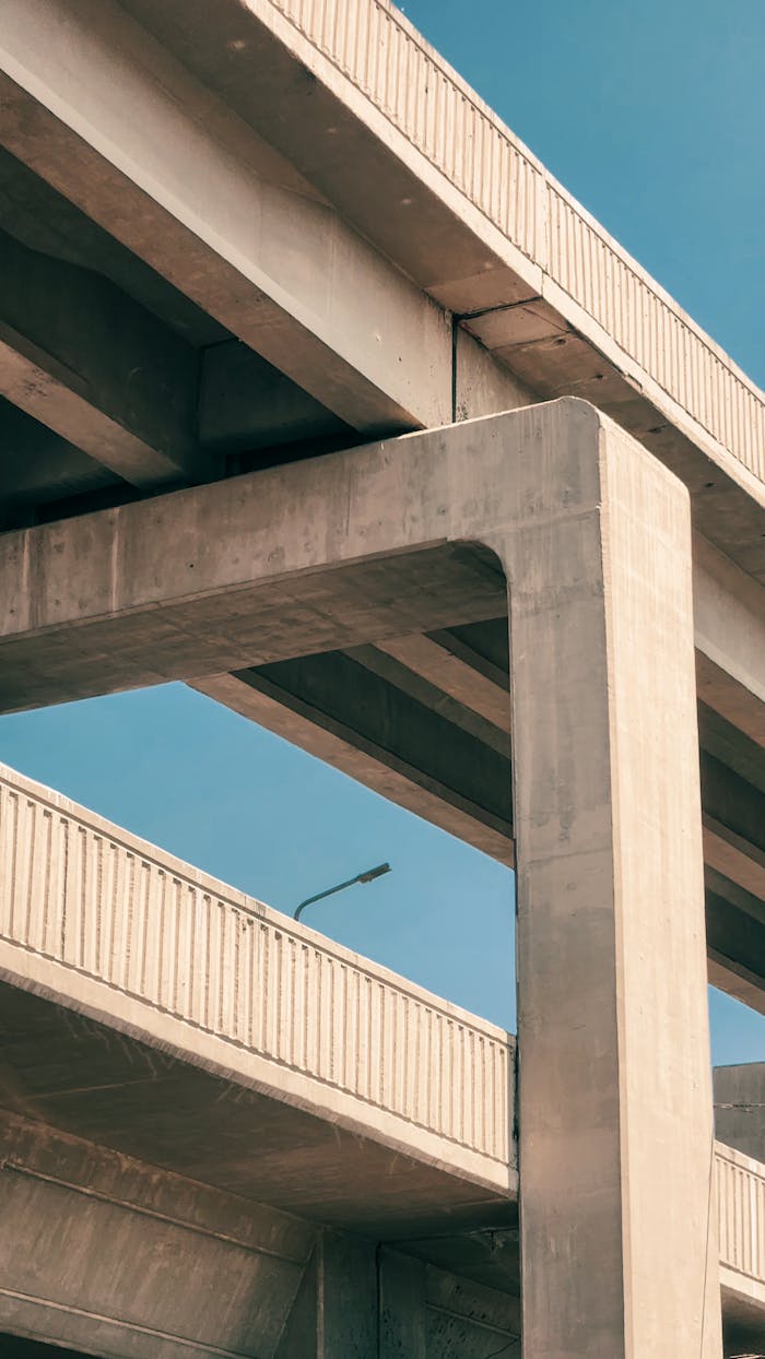 Home A towering concrete overpass structure with a clear blue sky background, showcasing modern architecture.